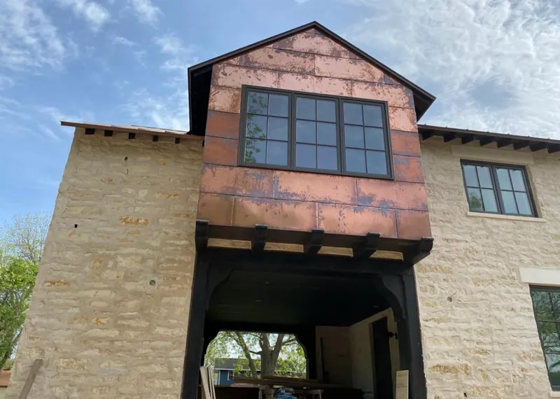 Copper metal panel facade on a stone building for Roof Repair in Ridgefield