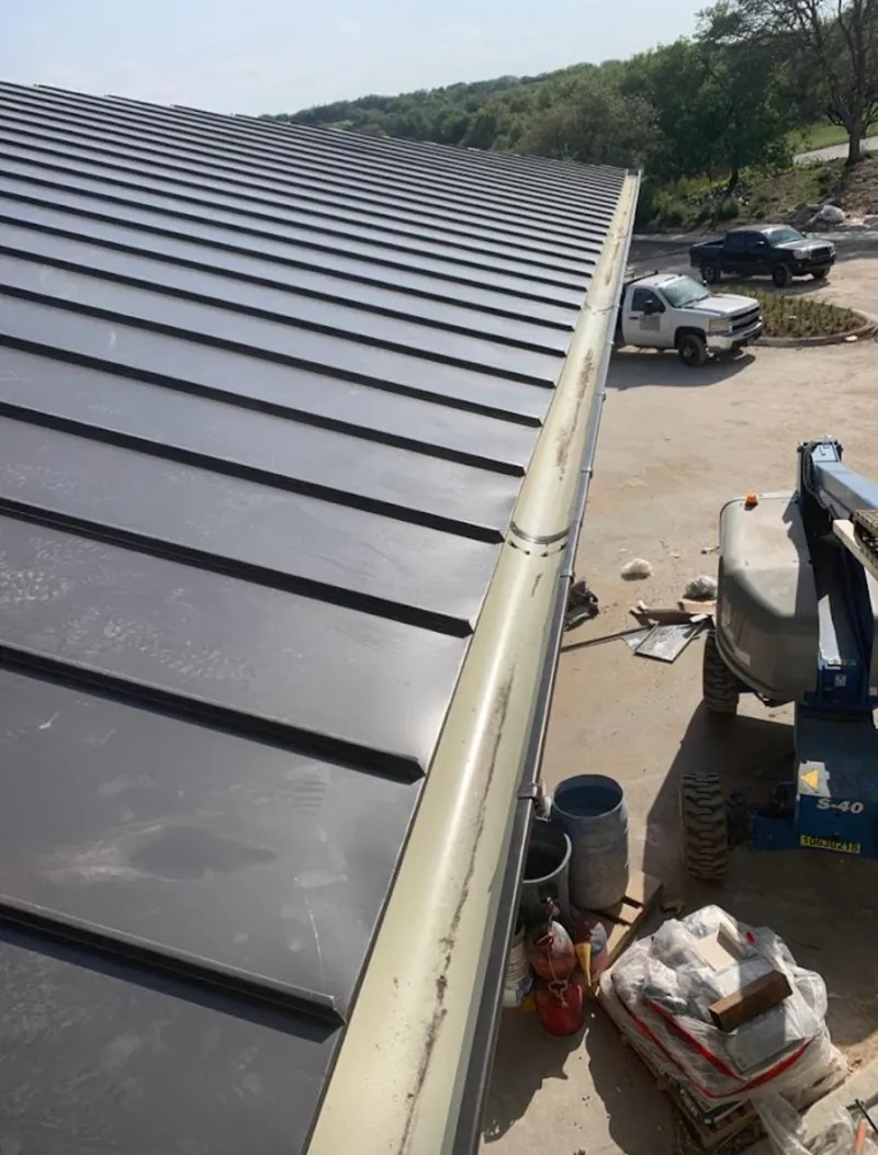 Standing seam panel and gutter detail on a metal roofing jobsite in Ridgefield